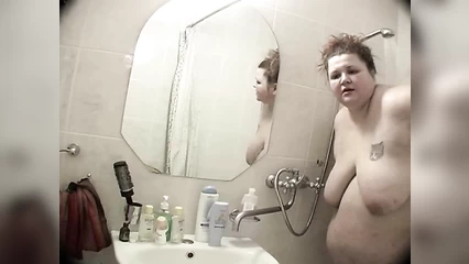 Fat woman has difficulty taking a shower in the bathroom