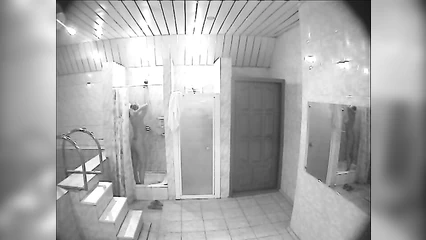 Tattooed girl washes her hair and body in the sauna shower