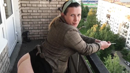 With a bare ass on the balcony