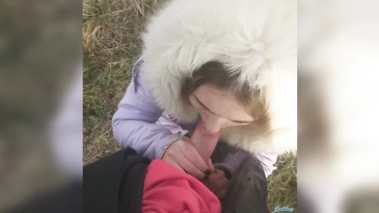 Young girl sucks outdoors