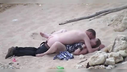 A man fries a drunk woman on the beach