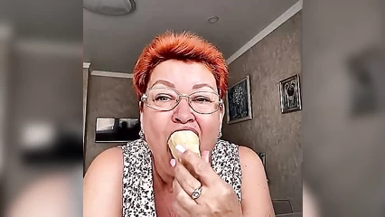 Red-haired bitch swallows ice cream