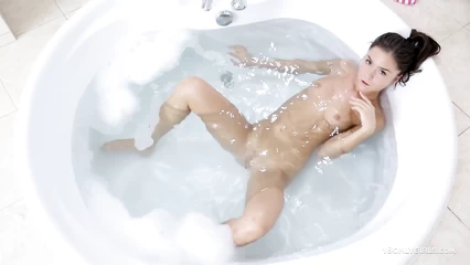 Brunette takes a bubble bath