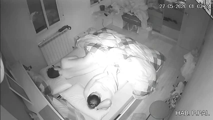 The husband is sleeping and the woman is masturbating