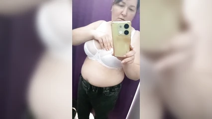 Busty mature woman in the fitting room