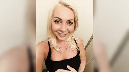 A mature Muscovite exposes herself in a shopping mall restroom.