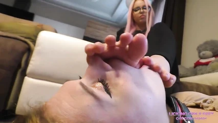 The slave likes to lick her mistress's feet