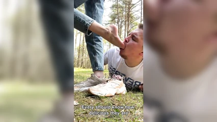 Licking the mistress's feet in the forest
