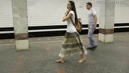 A modest girl in a long skirt walks without shoes