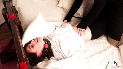 Brunette tied to a bed and tickled with a feather