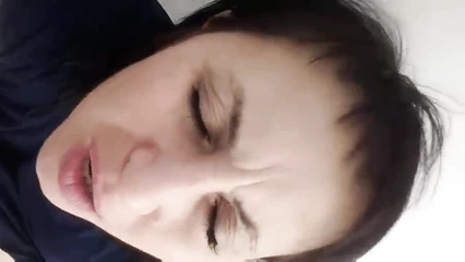 The lady touches herself with her hands and moans