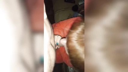 A man gives his red-haired wife a cheek