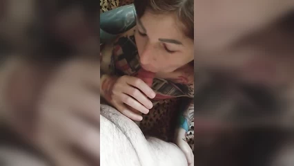 A girl in tattoos takes it in her mouth