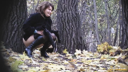 Business lady peeing under a tree