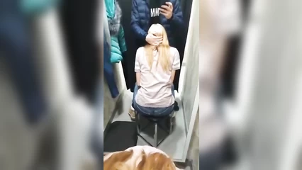 Blonde gives friend a blowjob in the fitting room